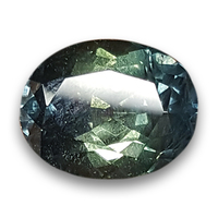 This large 9 carat oval shape natural untreated green sapphire is from the Umba River region of Tanzania in Africa.  This rare unheated blue green sapphire has a soft color palette yet stays neutral in the cooler gray tones with an almost bicolor loo