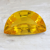 Very large intense half moon golden yellow sapphire.  This yellow sapphire is very clean and lively. Weighing in at over 9 carats this fancy shape yellow sapphire would make a stunning statement piece.