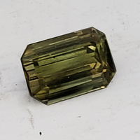 2 + carat emerald-cut untreated army green sapphire is from the Umba River region of Tanzania in Africa.  This lively unheated rich olive emerald-cut green sapphire is cut well in a traditional step-cut. Pretty and Rare!