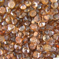 Calibrated diamond cut round brown zircon melee in every tenth-of-a-millimeter .  This clean natural zircon is available in various shades of brown from cognac color to chocolate color zircons and is very lively.  These brown zircons could be us