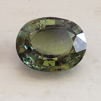 Lively 3 + carat unheated oval green sapphire from the Umba River region of Tanzania in Africa.  This rare untreated green sapphire oval is well cut and  has a slight color change with natural light. 