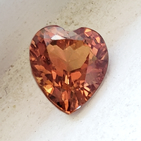 Lively natural unheated orange sapphire heart.  This beautiful and rare heart shape orange sapphire aka African padpardscha is from the Umba Valley region of Africa and has sparkling golden undertones.