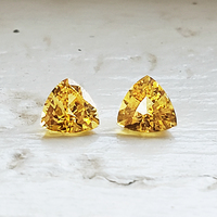 Matching pair of 5mm trillion fancy yellow sapphires. This pair of 5 millimeter yellow sapphire trillions are clean and full of life. This would be a perfect triangle lemon yellow sapphire pair as side stones for a ring or beautiful yellow sapphire earrin