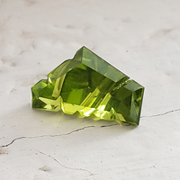 This nice bright fancy shape peridot is clean and lively.  This custom cut fantasy shape untreated peridot is the August birthstone and has a lovely chartreuse green color with flashes of lime yellow typical of fine Arizona peridot.
