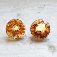 Matching pair of round golden yellow sapphires. This pair of 5.6 mm yellow peach sapphires are clean and brilliant. Nice round yellow sapphire pair as side stones for a ring or beautiful yellow sapphire earrings!